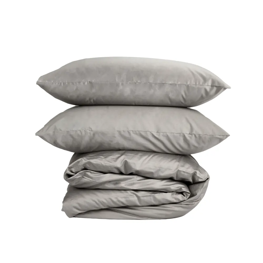 A duvet encased in a grey coloured hotel quality duvet cover with two pillows encased in Hotel Pure Luxury grey coloured pillowcases on top of it.