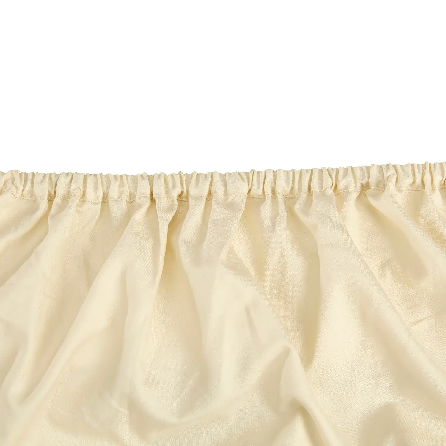 A close-up view of a Hotel Pure Luxury branded cream coloured cotton fitted sheet.