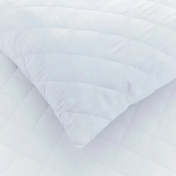 A close up view of a cotton quilted pillow protector from the Vision Essentials range.