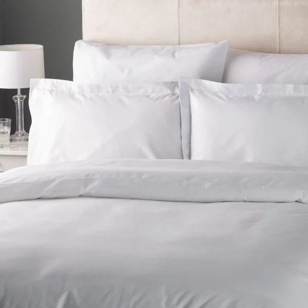 A cotton rich plain white duvet cover from the Vision Essentials range. Pictured with cotton rich pillowcases from the same range.