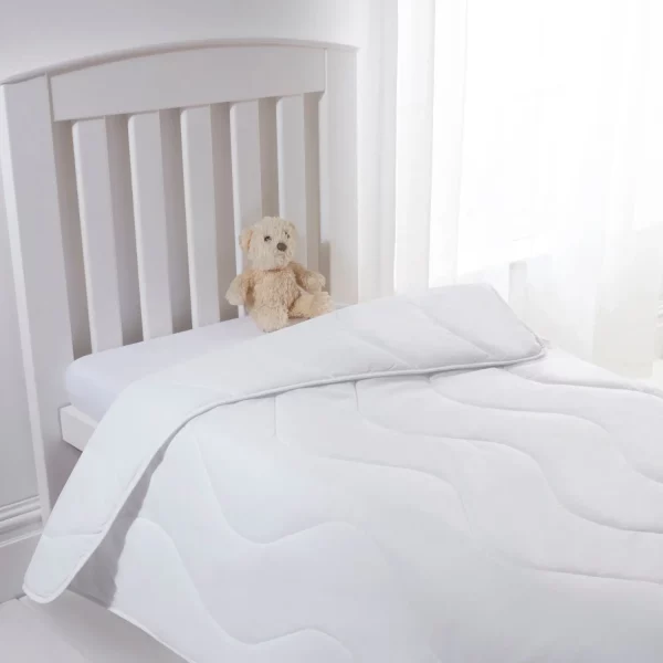 A Clair De Lune anti-allergy 4 tog single duvet on a child's bed. There is also a brown teddy bear sitting on the mattress.