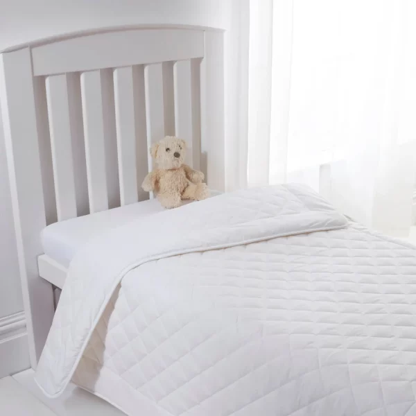 A Clair De Lune anti-allergy 4 tog wool single duvet on a child's bed. There is also a brown teddy bear sitting on the mattress.