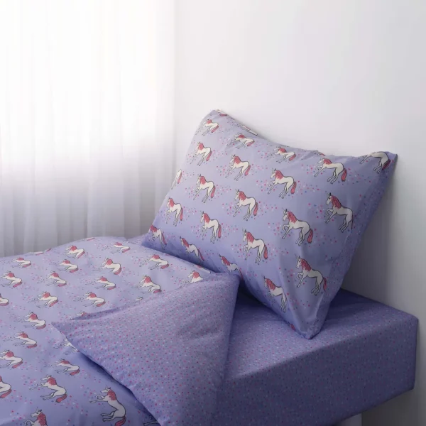 A lilac unicorn patterned duvet cover and pillowcase set from Rachel Riley. The pattern includes white unicorns with pink hair, surrounded by multi-coloured love hearts.