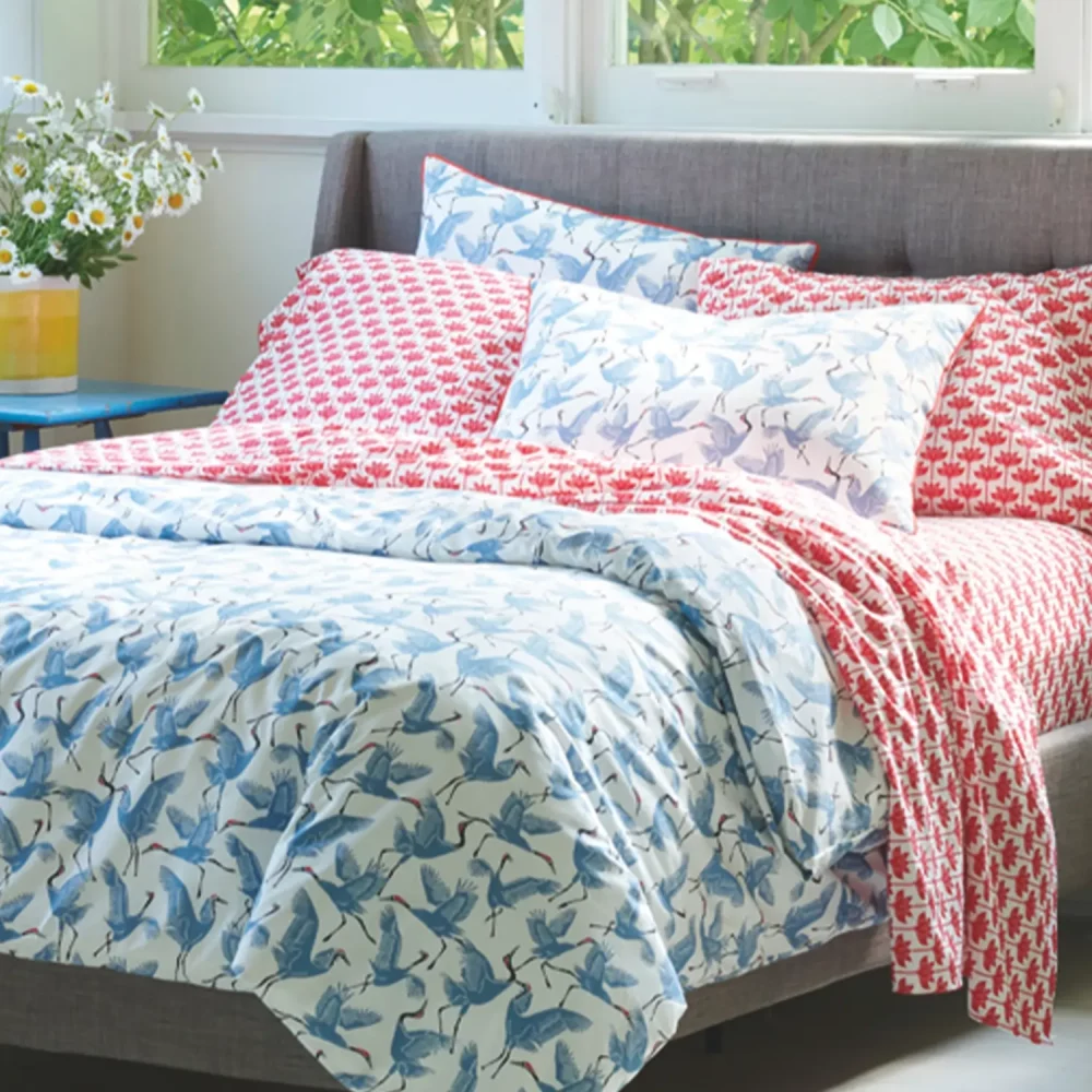 Another angle of a blue patterned family of cranes duvet cover and pillowcase set