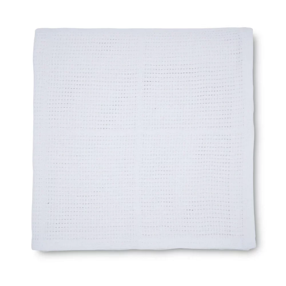 A white cellular blanket for use with babies from the Martex Baby range