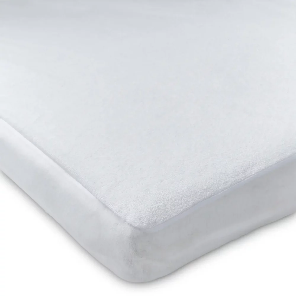 A white waterproof anti-allergy towelling cot bed mattress protector.