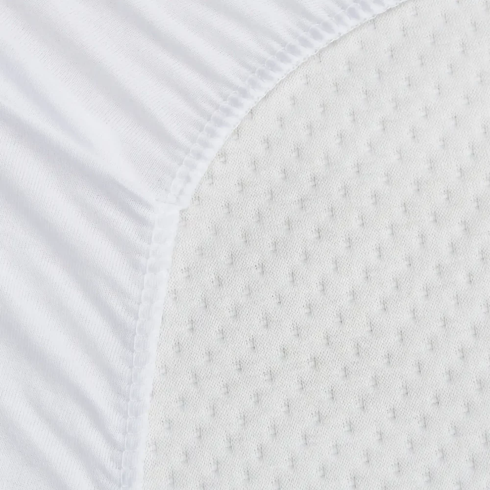 A close up of a white waterproof anti-allergy towelling cot bed mattress protector.