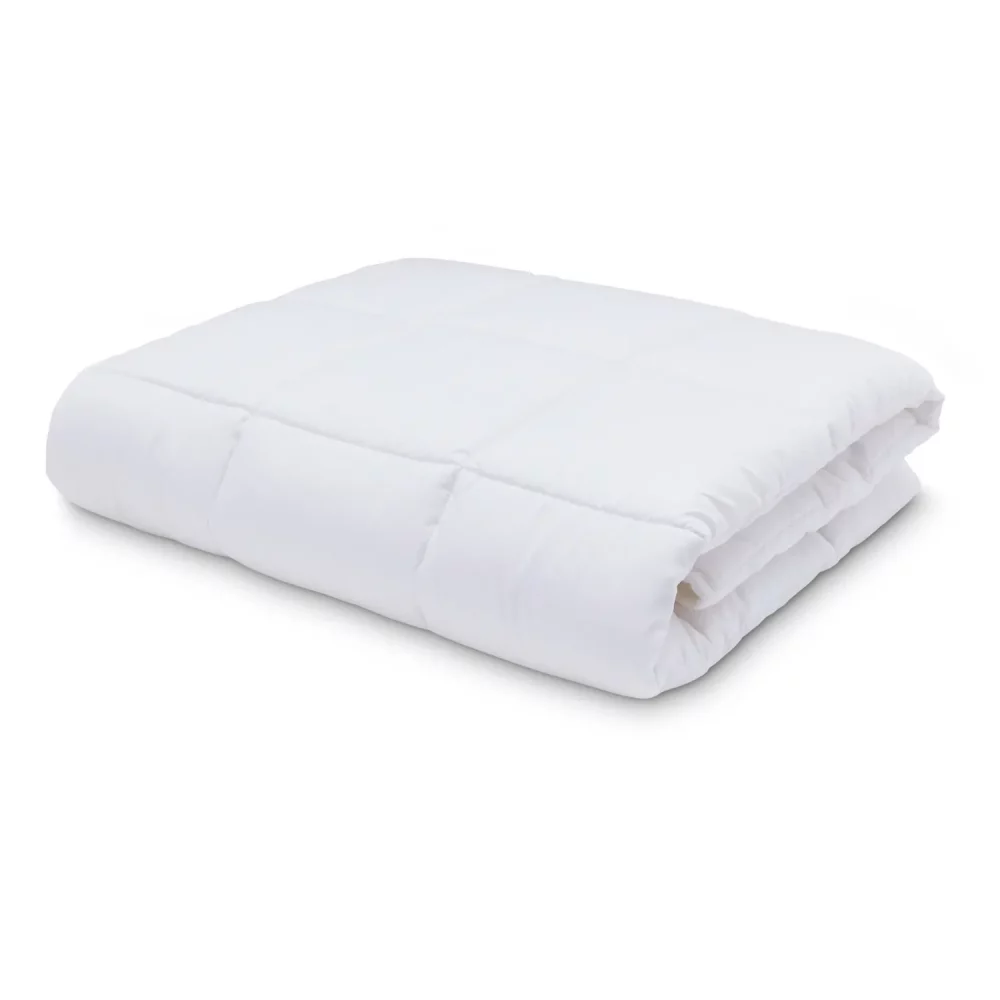 An anti-allergy 4 tog cot duvet from Martex Baby on a white background. The duvet is folded up.