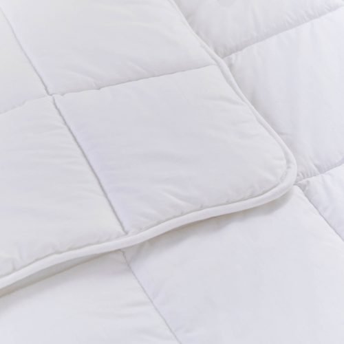 A close up look at a white anti-allergy 4 tog cot bed duvet from Martex Baby. The duvet has a square grid design.