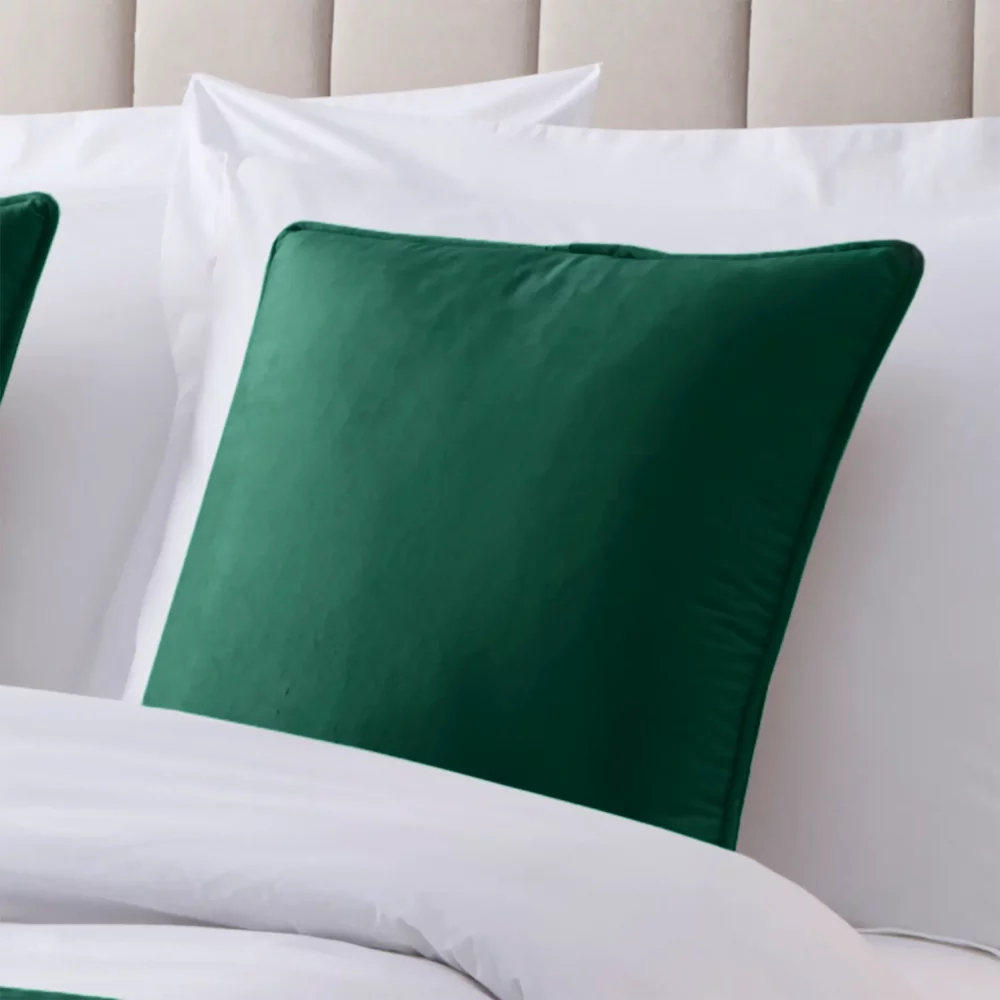 Emerald Green Martex Velvet Piped Cushion Cover on a bed