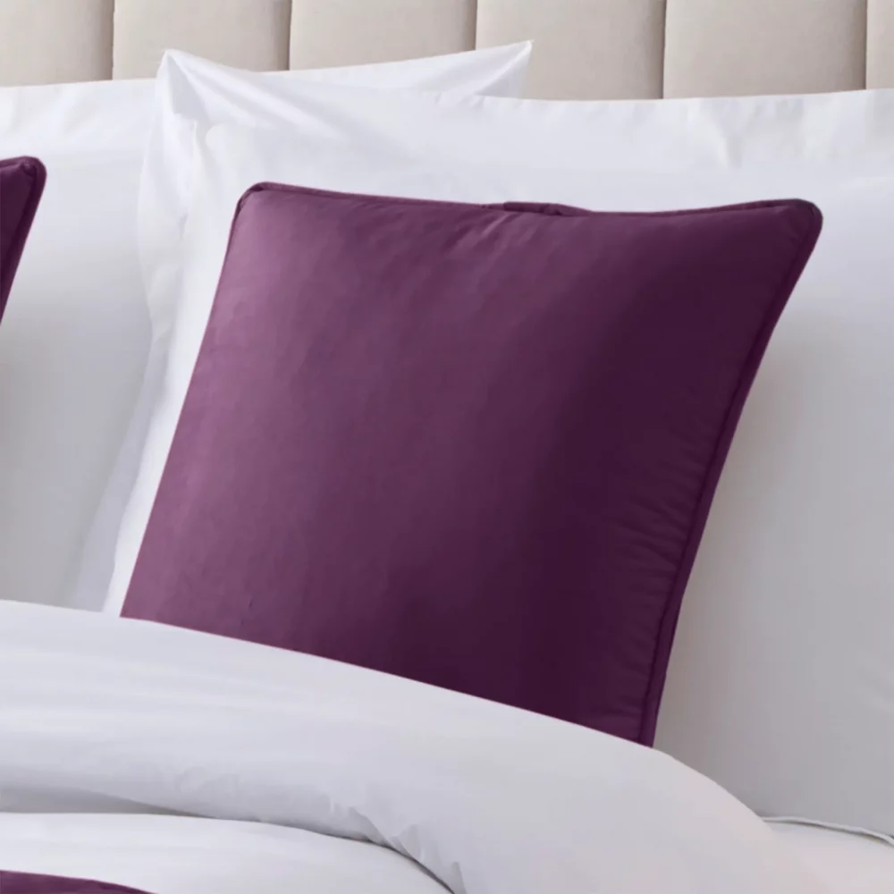 Aubergine Martex Velvet Piped Cushion Cover on a bed