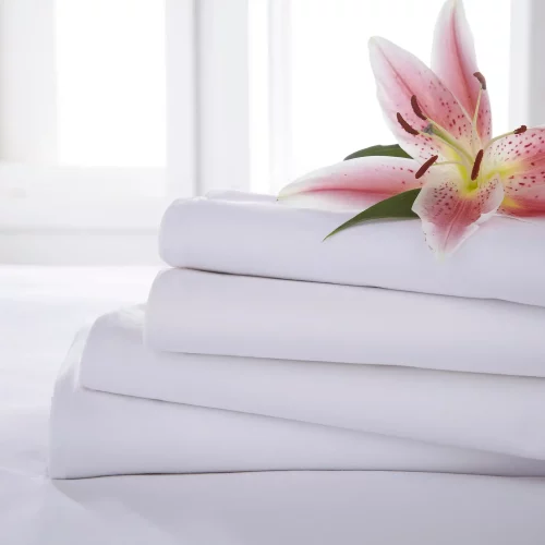 Close up of four White Martex Percale Flat Sheets stacked on one another