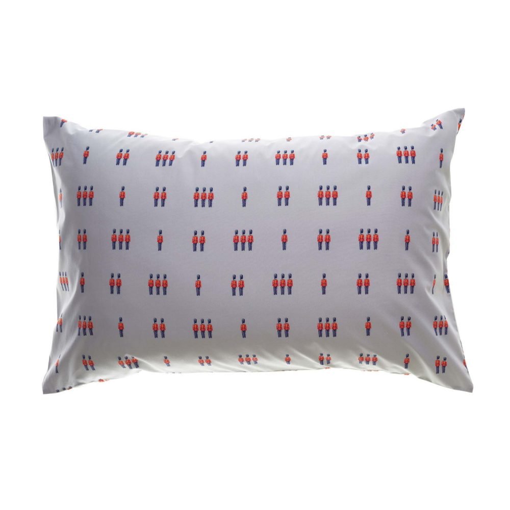 A white pillowcase from Rachel Riley. It features a print of small toy beefeater soldiers in red and blue.