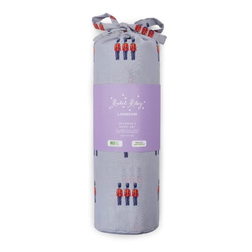 The packaging for a white duvet cover and pillowcase set from Rachel Riley. It features a print of small toy beefeater soldiers in red and blue.