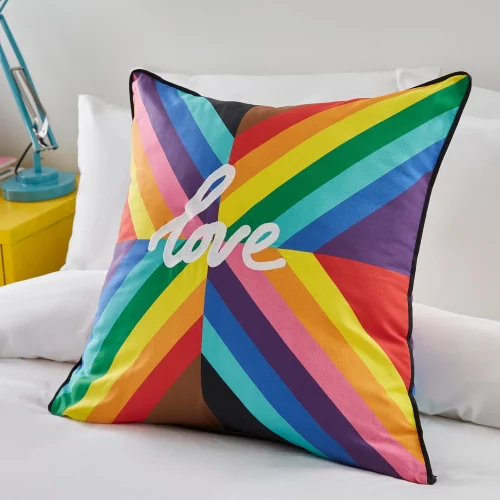 A multi-coloured rainbow cushion from Martex Pride. It has the word 'Love' in the middle of it.